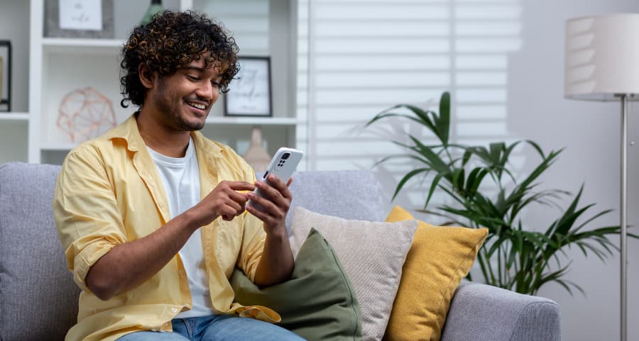 Man using a home security app on his smartphone